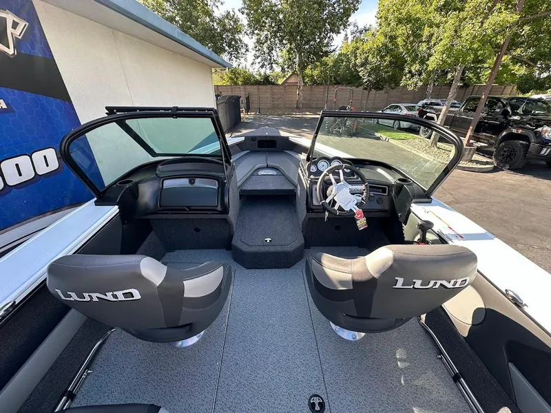 Slide: The Image of 2025 Lund 1875 Crossover XS boat interior with dual seats and steering console. - 12