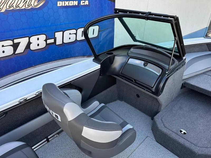 Slide: The Image of 2025 Lund 1875 Crossover XS boat interior with seating and dashboard view. - 18