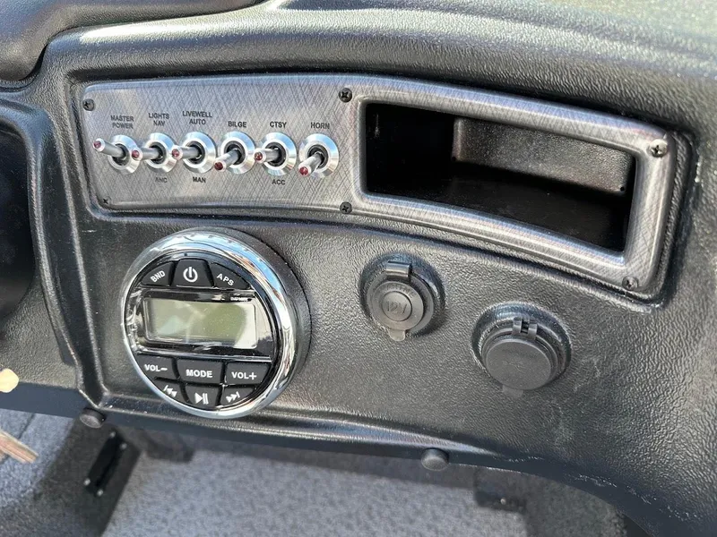 Slide: The Image of Control panel of 2025 Lund 1875 Crossover XS boat with switches and audio controls. - 24