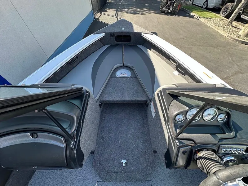 Slide: The Image of 2025 Lund 1875 Crossover XS boat interior with dashboard and seating area. - 25