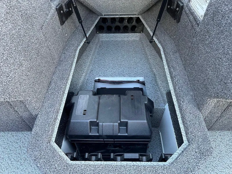 Slide: The Image of 2025 Lund 1875 Crossover XS boat storage compartment with battery box. - 29