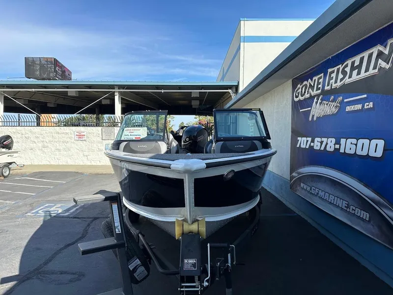 Slide: The Image of 2025 Lund 1875 Crossover XS boat displayed at a dealership, front view. - 3