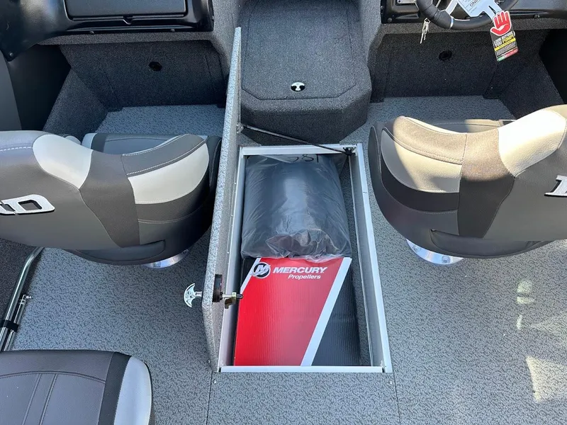 Slide: The Image of 2025 Lund 1875 Crossover XS boat interior with storage compartment and Mercury propellers. - 30
