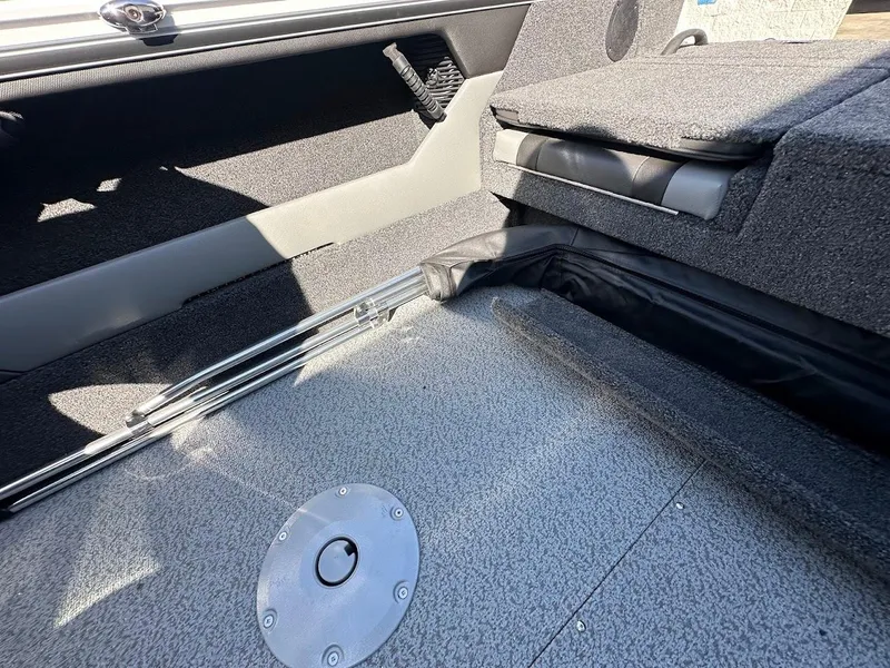 Slide: The Image of Interior of 2025 Lund 1875 Crossover XS boat, featuring seating and storage area. - 33