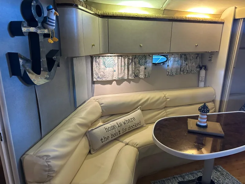 Slide: The Image of Interior of a 1997 Regal Commodore 402 with nautical decor and cozy seating area. - 44