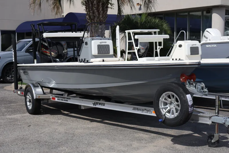 The Image of 2025 Hewes Redfisher 18 boat on trailer, displayed at dealership. - 0