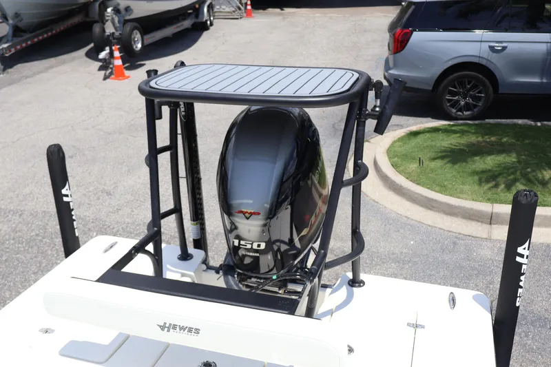Slide: The Image of 2025 Hewes Redfisher 18 boat displayed in a parking lot with other boats. - 10