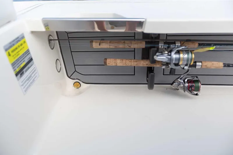 Slide: The Image of 2025 Hewes Redfisher 18 boat with 150 HP engine, parked outdoors. - 11