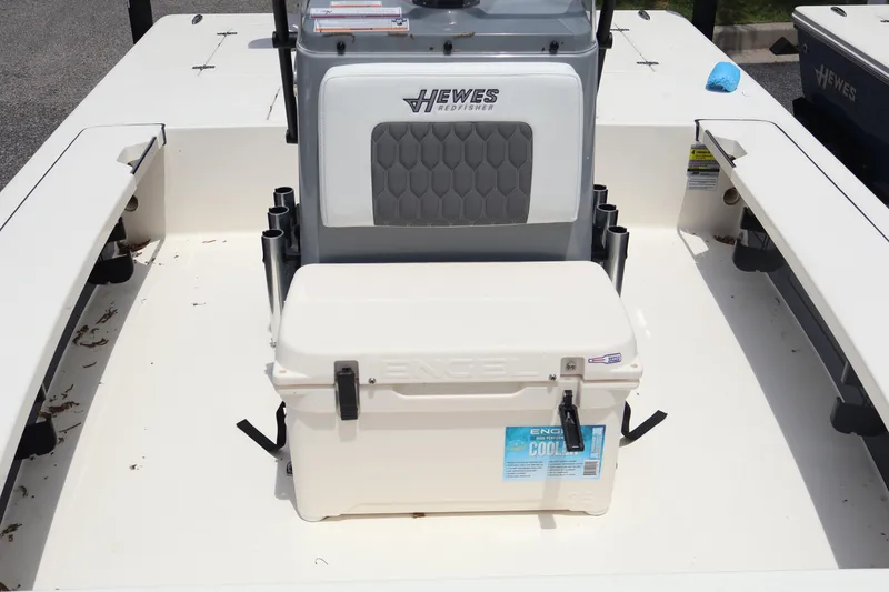 Slide: The Image of 2025 Hewes Redfisher 18 boat storage compartment with open lid, showcasing interior space. - 19