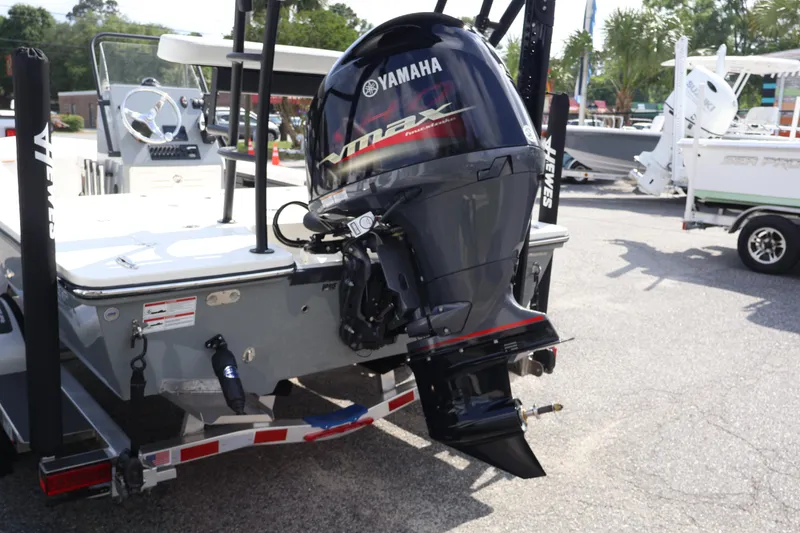 Slide: The Image of 2025 Hewes Redfisher 18 boat on trailer at dealership, side view. - 3