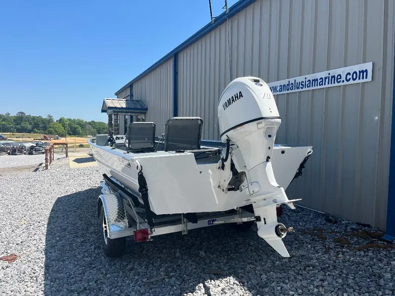 Slide: The Image of 2025 Alweld 1856 Panfish boat with Yamaha motor on trailer, parked outside. - 4