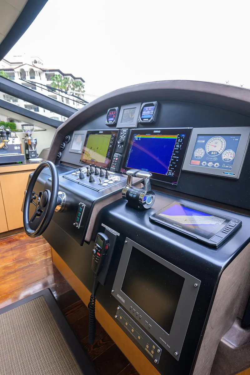 Slide: The Image of 2009 Pershing 90 Express yacht cockpit with advanced navigation systems and controls. - 16