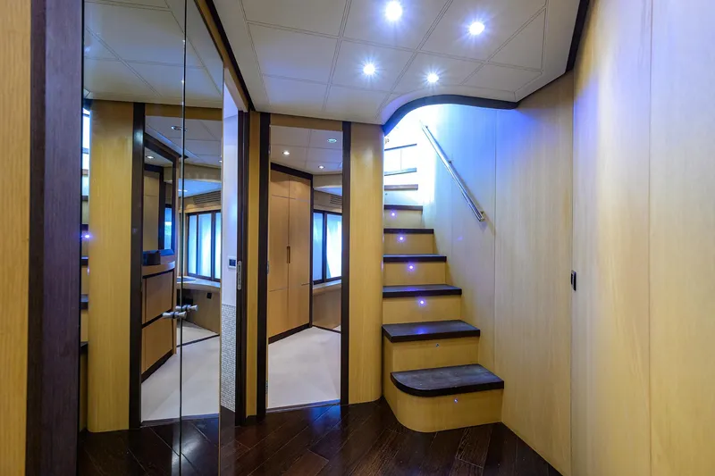 Slide: The Image of Luxurious interior of 2009 Pershing 90 Express yacht with modern staircase and ambient lighting. - 17