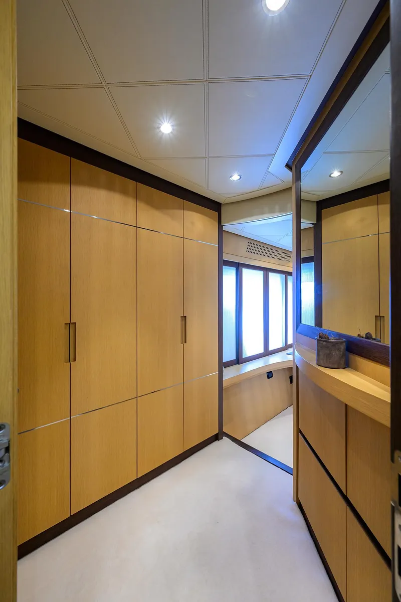 Slide: The Image of Luxurious interior of 2009 Pershing 90 Express yacht with sleek wooden cabinetry and modern lighting. - 18