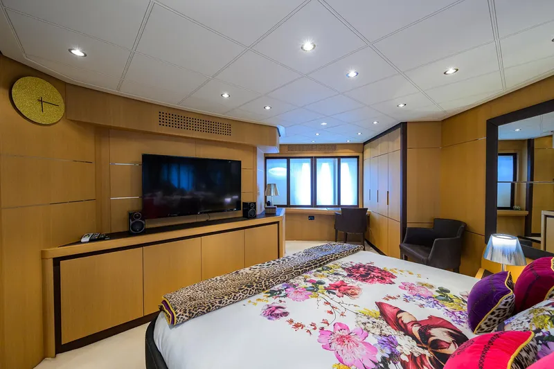 Slide: The Image of Luxurious bedroom interior on 2009 Pershing 90 Express yacht, featuring modern decor and floral bedding. - 22