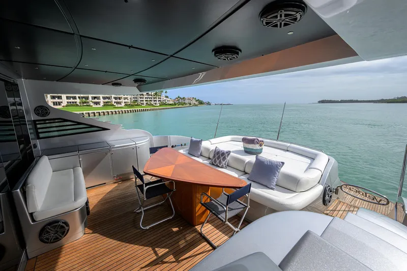 Slide: The Image of Luxurious 2009 Pershing 90 Express yacht deck with seating, table, and scenic ocean view. - 37