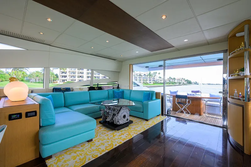 Slide: The Image of Luxurious interior of 2009 Pershing 90 Express yacht with turquoise seating and scenic view. - 9