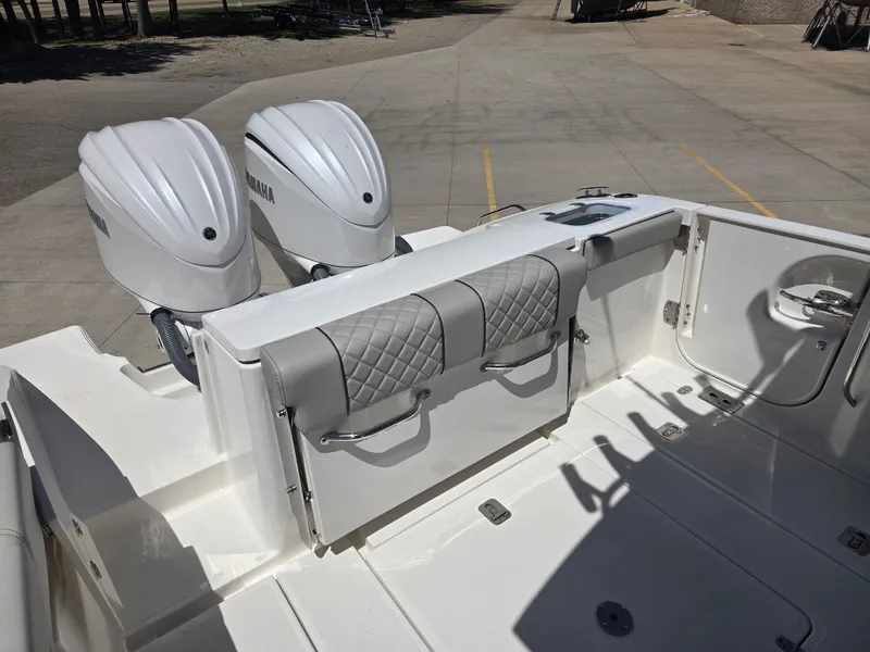 Slide: The Image of 2025 Pursuit S 288 Sport boat with dual engines and cushioned seating. - 10