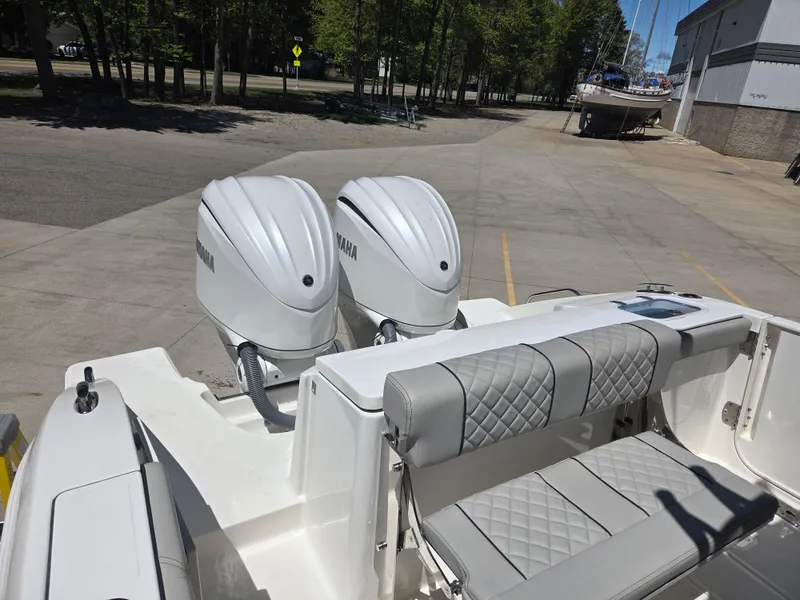 Slide: The Image of 2025 Pursuit S 288 Sport boat with dual Yamaha engines and quilted seating. - 11