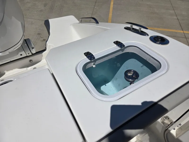 Slide: The Image of 2025 Pursuit S 288 Sport boat with livewell on deck, showcasing modern design. - 13