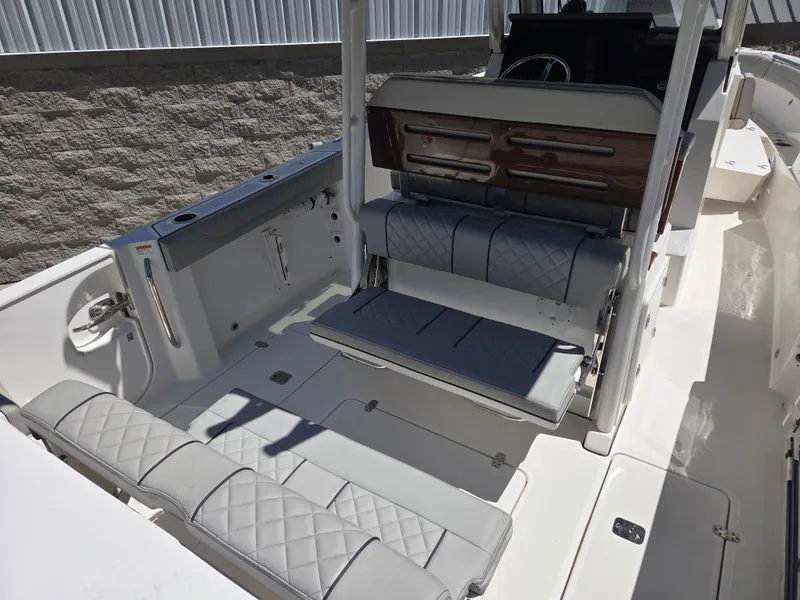 Slide: The Image of 2025 Pursuit S 288 Sport boat interior with gray seating and modern design. - 15