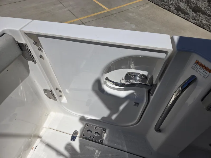 Slide: The Image of 2025 Pursuit S 288 Sport boat interior with open hatch and stainless steel handle. - 18