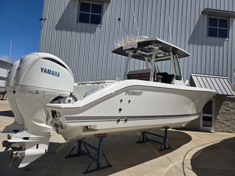 Slide: The Image of 2025 Pursuit S 288 Sport boat with Yamaha engine on stands, outdoor setting. - 2