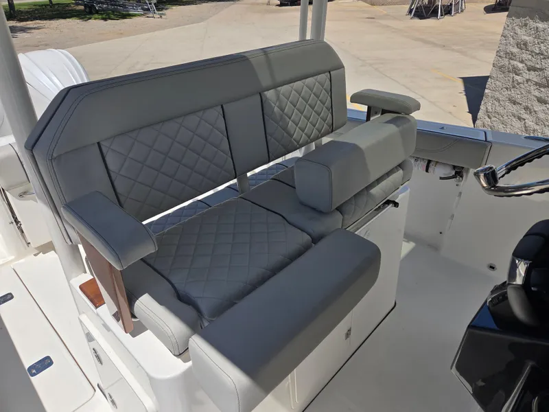 Slide: The Image of 2025 Pursuit S 288 Sport boat with gray quilted seating and armrests. - 20