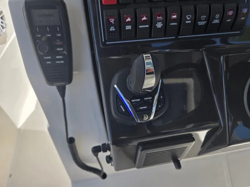 Slide: The Image of Control panel of a 2025 Pursuit S 288 Sport boat with joystick and radio. - 27