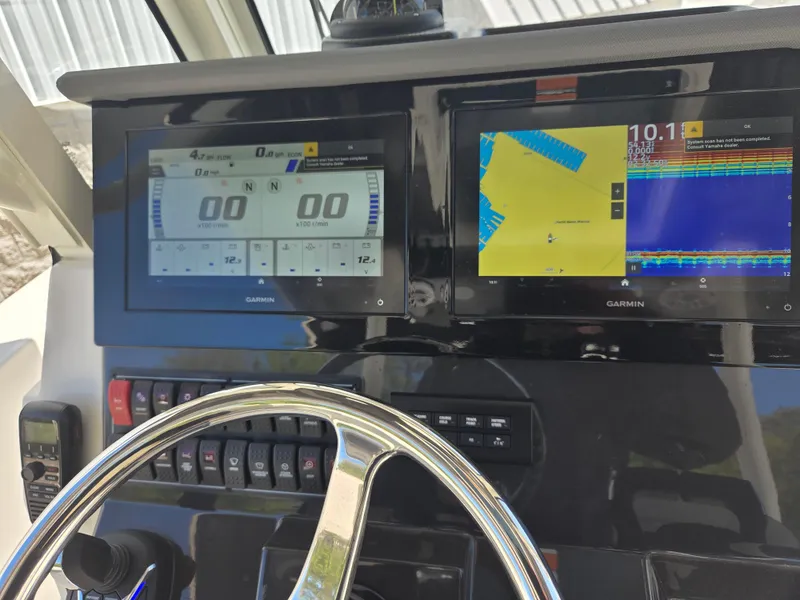 Slide: The Image of Dashboard of 2025 Pursuit S 288 Sport boat with Garmin navigation displays. - 28