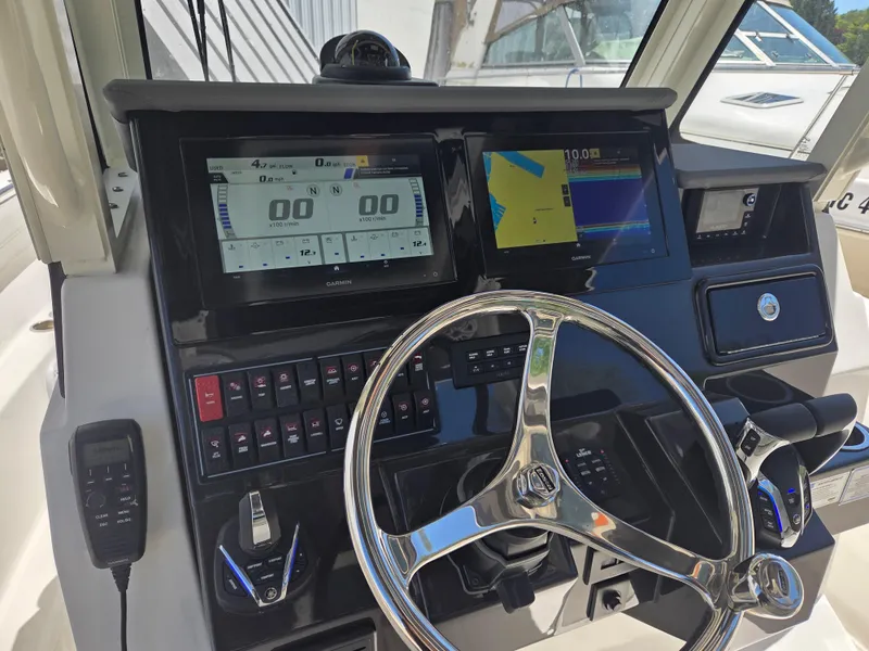 Slide: The Image of Dashboard of 2025 Pursuit S 288 Sport boat with modern controls and navigation screens. - 30