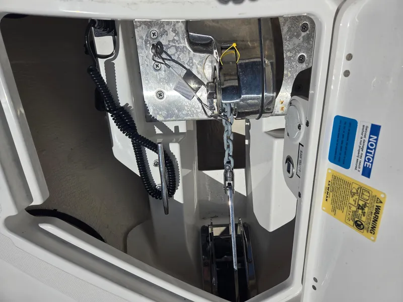 Slide: The Image of 2025 Pursuit S 288 Sport boat anchor winch system with safety notices. - 32