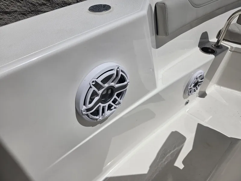 Slide: The Image of 2025 Pursuit S 288 Sport boat interior with built-in speakers and seating area. - 33