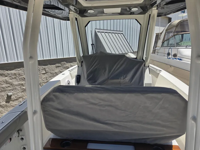 Slide: The Image of 2025 Pursuit S 288 Sport boat interior with covered seating and modern design. - 35