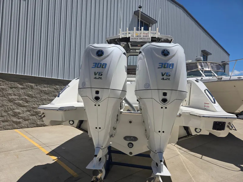 Slide: The Image of 2025 Pursuit S 288 Sport boat with twin 300 V6 engines, docked outdoors. - 4