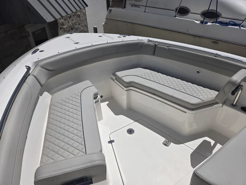 Slide: The Image of 2025 Pursuit S 288 Sport boat interior with gray cushioned seating and sleek design. - 5