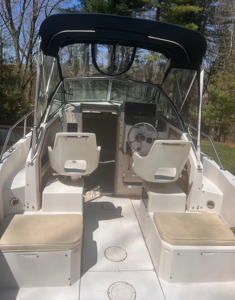 Slide: The Image of 1992 Grady-White 22 Seafarer boat interior with seating and steering wheel, under a canopy. - 12