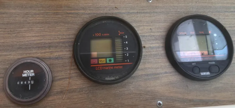 Slide: The Image of 1992 Grady-White 22 Seafarer dashboard with hour meter and LCD marine gauges. - 17