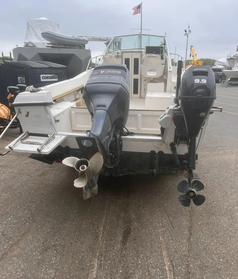 Slide: The Image of 1992 Grady-White 22 Seafarer boat with dual outboard motors, docked on a cloudy day. - 5