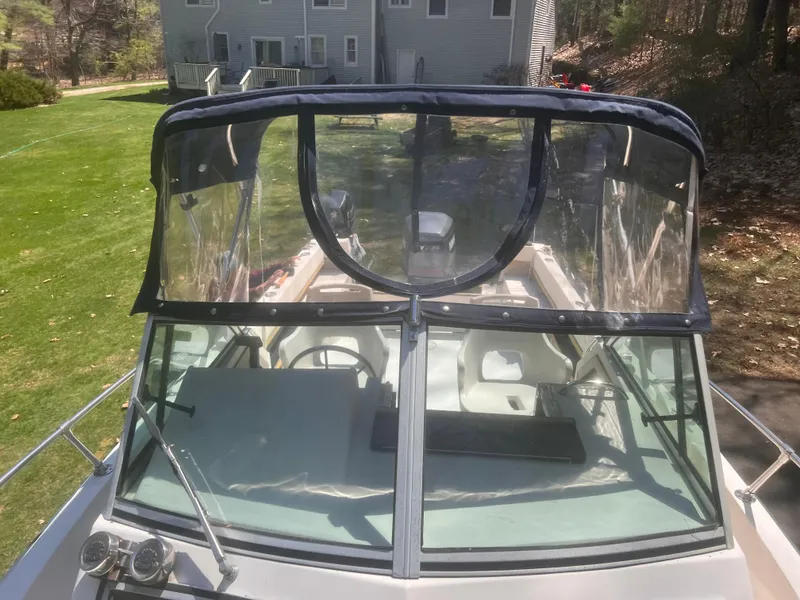 Slide: The Image of 1992 Grady-White 22 Seafarer boat with clear canopy, parked on grass. - 7