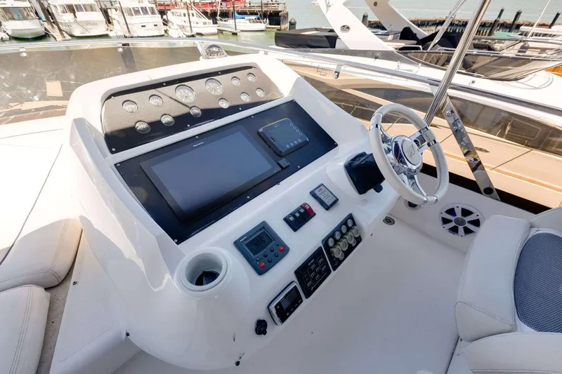 Slide: The Image of Helm of 2009 Sunseeker Manhattan 70 yacht with modern navigation controls and steering wheel. - 14