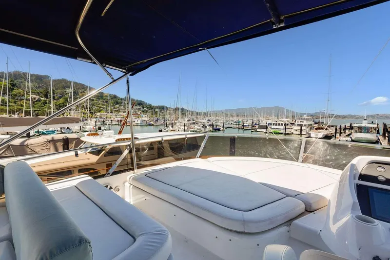 Slide: The Image of Luxurious 2009 Sunseeker Manhattan 70 yacht docked in a scenic marina setting. - 15