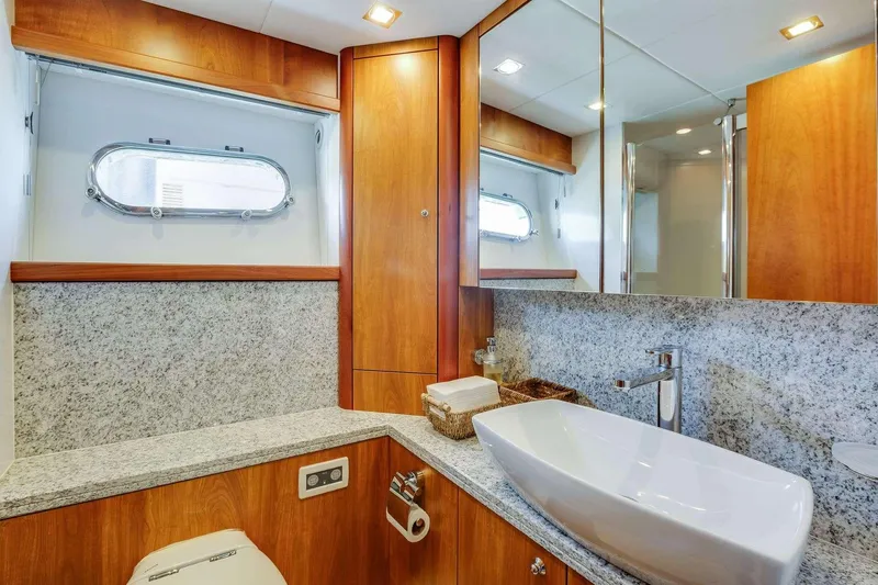 Slide: The Image of Luxurious bathroom in 2009 Sunseeker Manhattan 70 yacht with modern fixtures and wood accents. - 16