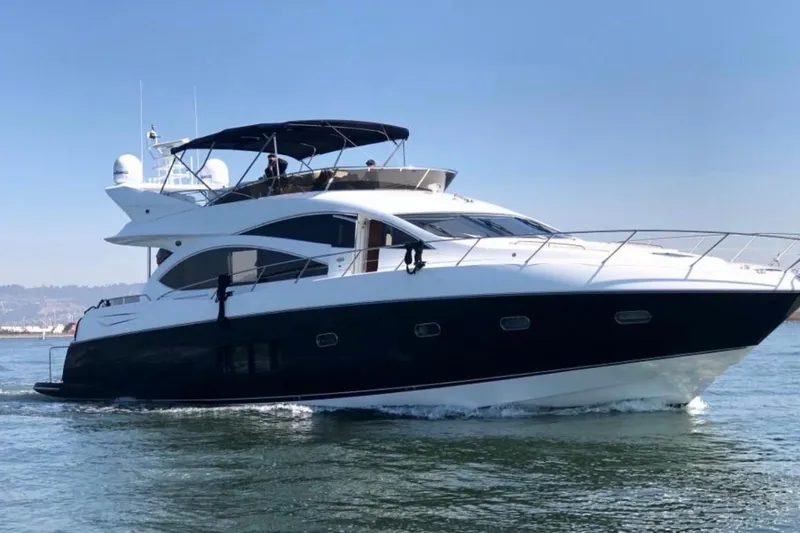 Slide: The Image of 2009 Sunseeker Manhattan 70 yacht cruising on open water. - 2