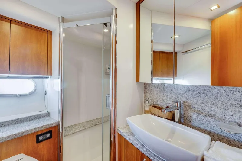 Slide: The Image of Luxurious bathroom in 2009 Sunseeker Manhattan 70 yacht with modern fixtures and wood accents. - 24