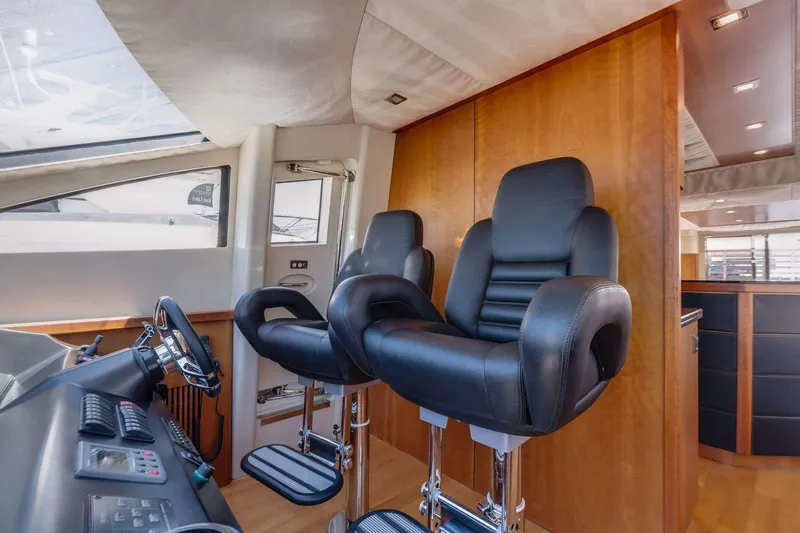Slide: The Image of Interior of 2009 Sunseeker Manhattan 70 yacht with two black captain chairs. - 25