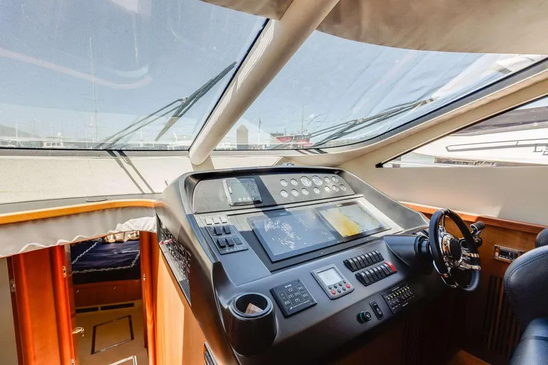 Slide: The Image of Cockpit of 2009 Sunseeker Manhattan 70 yacht with modern navigation controls and panoramic windows. - 26