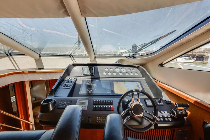 Slide: The Image of Helm of 2009 Sunseeker Manhattan 70 yacht with modern navigation controls and panoramic view. - 27