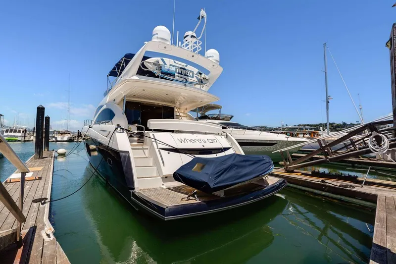 Slide: The Image of 2009 Sunseeker Manhattan 70 yacht docked at marina under clear blue sky. - 3