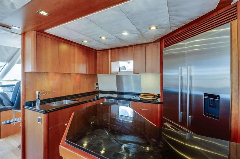 Slide: The Image of Luxurious kitchen interior of 2009 Sunseeker Manhattan 70 yacht with modern appliances and wood cabinetry. - 31